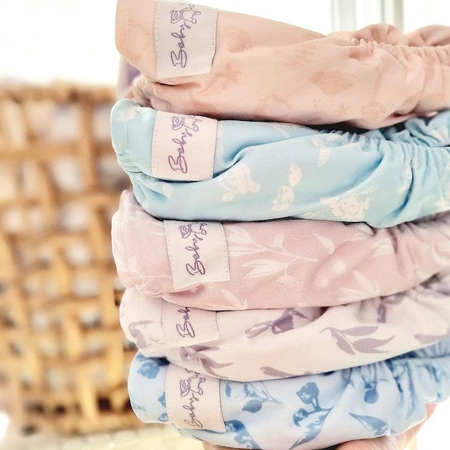 A stack of five pastel cloth nappies