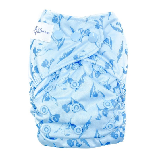 A reusable cloth nappy with a gumnut print on a blue base