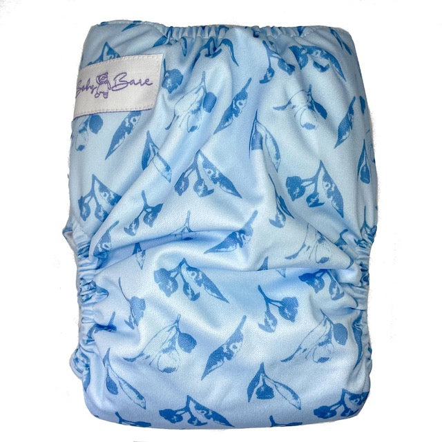 A reusable cloth nappy with a gumnut print on a blue base