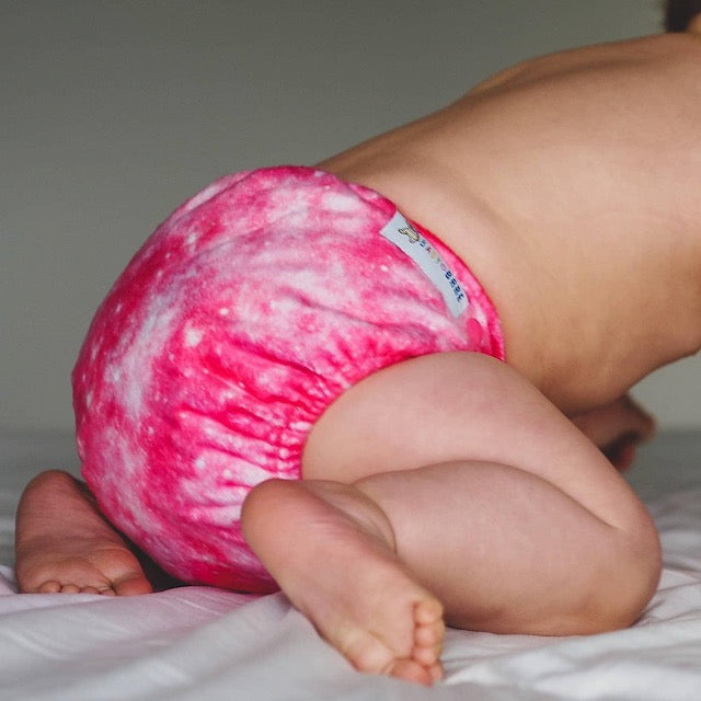 Baby wearing a soft pink minky cloth nappy