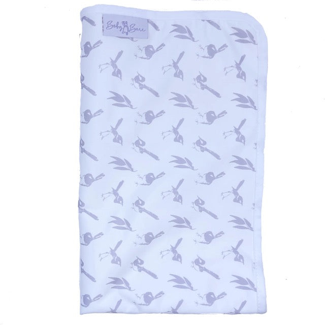 A folded white Baby Bare change mat featuring a lilac wren pattern