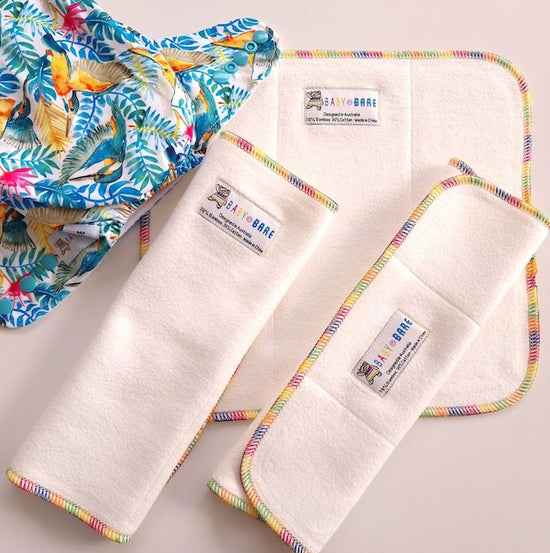 Baby Bare Tri-Fold nappy boosters and a colourful nappy with kingfisher print