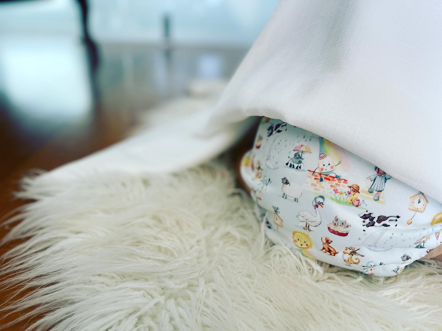 A cloth nappy featuring a Mother Goose print