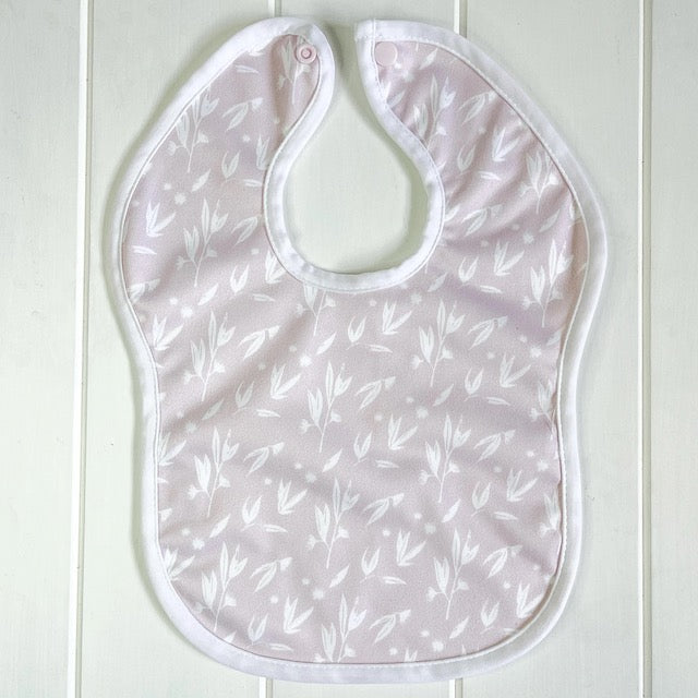 A pink baby bib featuring a blossom print