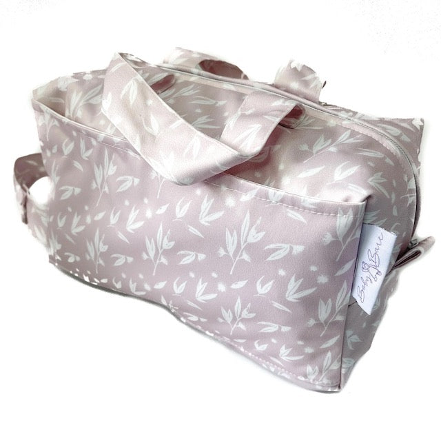 A pink pod style wet bag with a blossom design