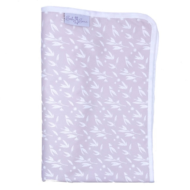 A folded pink Baby Bare change mat featuring a blossom pattern