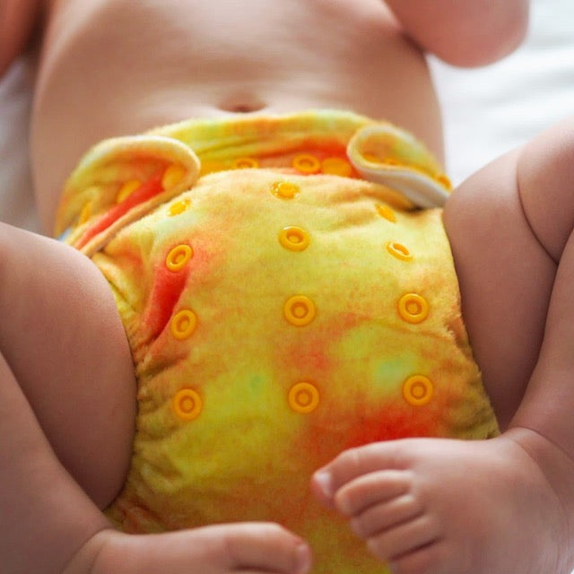 Baby wearing a soft yellow minky cloth nappy