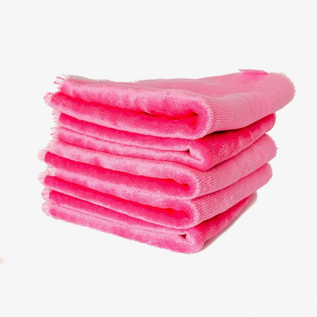A stack of hot pink cloth baby wipes