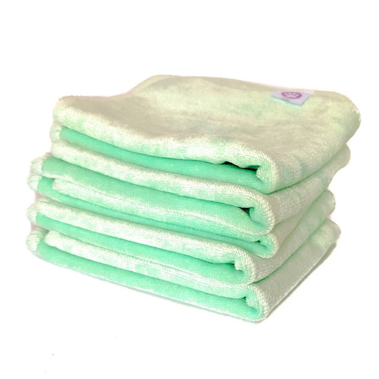 A stack of mint green cloth baby wipes
