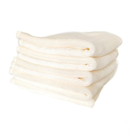 A stack of white cloth baby wipes