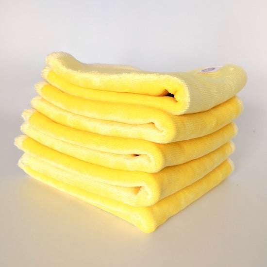 A stack of yellow cloth baby wipes