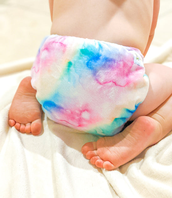 Baby wearing a soft watercolour minky cloth nappy
