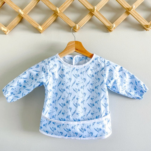 Blue baby feeding smock featuring gumnuts on a hanger