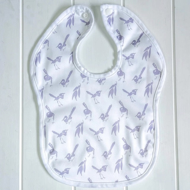 A white baby bib featuring a lilac wren print