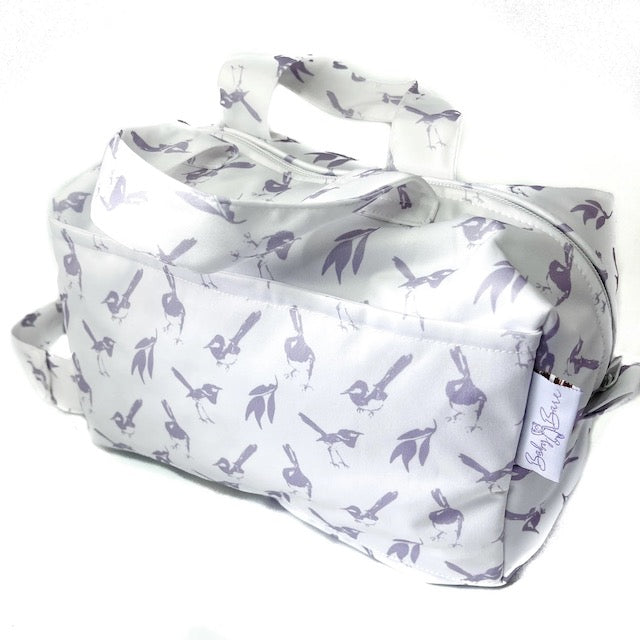 A white pod style wet bag with a lilac wren design