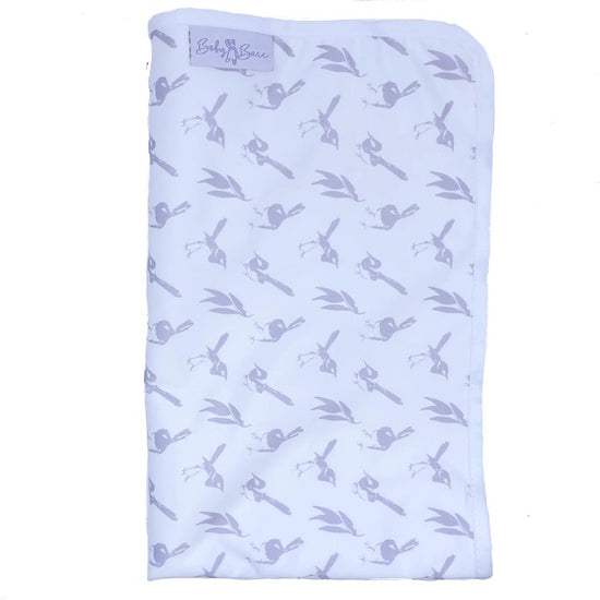 A folded white Baby Bare change mat featuring a lilac wren pattern