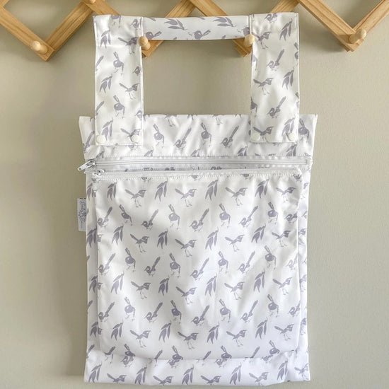 A white double wet bag with a lilac wren design on a hanger